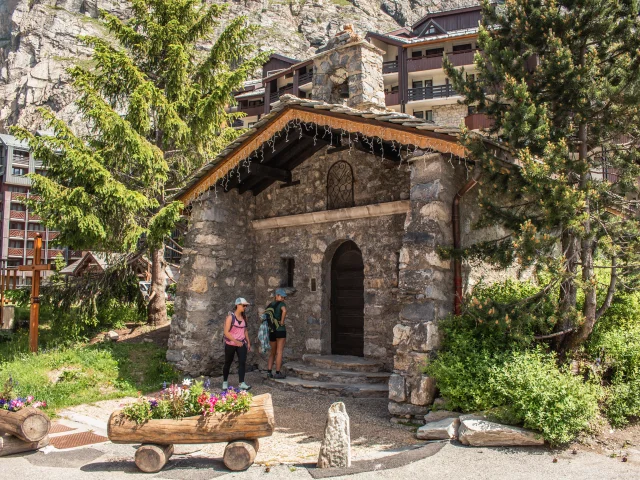 Amici a passeggio davanti alla cappella di Saint-Germain de La Daille in Val d'Isère in estate